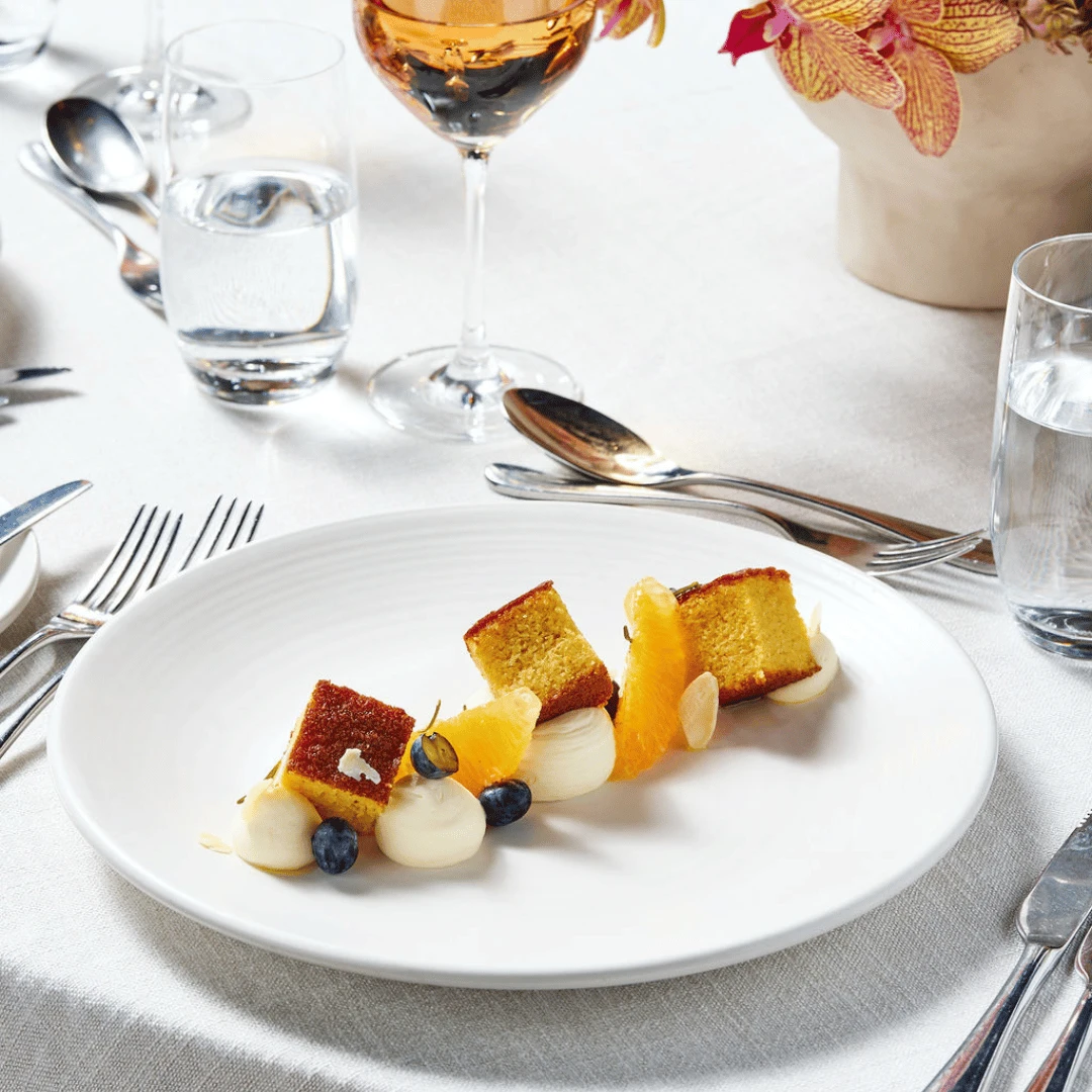 Orange almond cake, cardamom Chantilly, orange, blueberries, dried rosemary